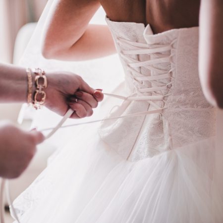 Bride gets dress adjusted